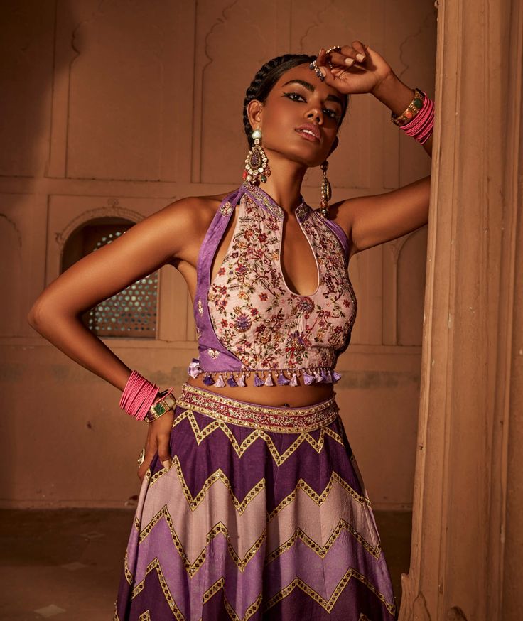 Make a style statement like a traditional diva in this alluring sharara set featuring geometrical print sharara coordinated with an intricately embroidered blouse with a stylised back design with heavy tassels and doris. Navratri Purple Palazzo Set With Cutdana, Bohemian Sharara With Cutdana For Reception, Purple Palazzo Set With Mirror Work For Festive Occasions, Embroidered Purple Sharara, Purple Georgette Palazzo Set, Bohemian Georgette Sharara For Reception, Bohemian Sets With Motifs, Bohemian Georgette Sharara For Designer Wear, Bohemian Designer Wear Sharara In Georgette