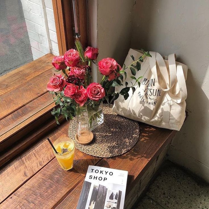 a table with flowers and a magazine on it