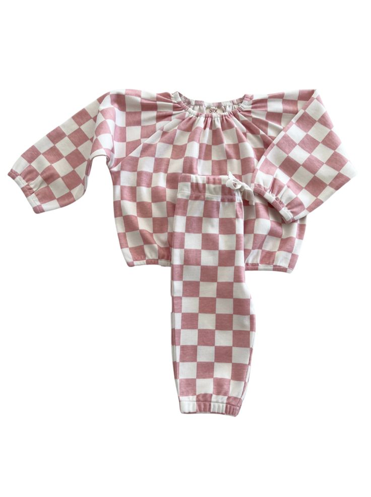 Checkerboard is bold and cheerful: perfect for your little one.The Organic Mode Top + Pant Set features soft 100% GOTS Certified Organic Cotton and is ready to be dressed up or down. Comfortable enough for a cozy day at home but also a complete outfit for running errands or playdates. Made in India 100% GOTS Certified Organic Cotton Machine Wash Cold By SIIX Collection Cozy Playtime Sets For Fall, Playful Cotton Bottoms In Matching Set, Cozy Pink Sets For Spring, Pink Loungewear Set With Elastic Waistband, Playful White Relaxed Fit Set, Playful White Set With Relaxed Fit, White Relaxed Fit Playwear Sets, Casual Pink Sets With Elastic Waistband, Casual Pink Set With Elastic Waistband