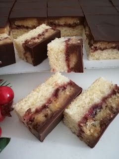 several slices of cake sitting on top of a white plate next to cherries and flowers