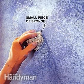 a person is painting a wall with blue paint and sponges on the side, labeled small piece of sponge