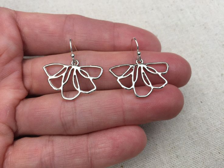 "These are unique, funky and whimsical silver flower earrings! They have such a fun and playful vibe with their modern design style. They are lightweight and comfortable. The perfect everyday earring, versatile and stylish. The earrings measure 5/8\" long by 1\" wide and hang from simple silver ear wire hooks. Overall drop length is 3/4\". Made from allergy free plated rhodium and silver. I have a matching necklace in my shop, if you would like the whole set. Here is the link Thanks for stopping Mother's Day Nickel-free Sterling Silver Flower Earrings, Silver Flower Metal Earrings For Spring, Silver Metal Flower Earrings For Spring, Flower-shaped Nickel-free Earrings For Mother's Day, Silver Flower Earrings For Spring, Silver Flower Shaped Earrings For Spring, Nickel-free Flower-shaped Earrings For Mother's Day, Nickel Free Flower Shaped Earrings For Mother's Day, Spring Silver Metal Flower Earrings