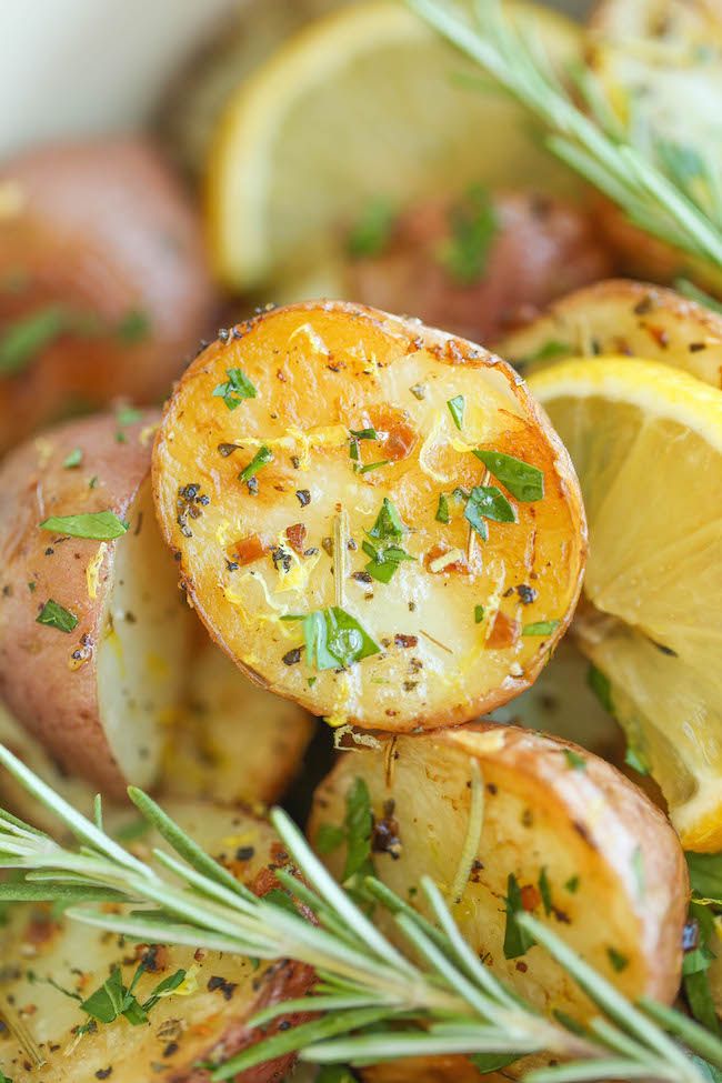 potatoes and lemons with herbs in a white bowl