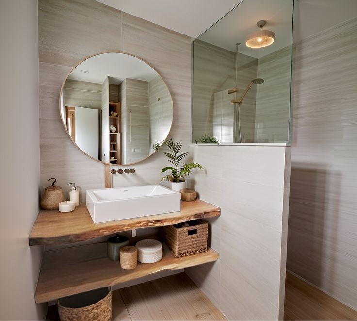 a bathroom with a sink, mirror and shelves on the wall in front of it