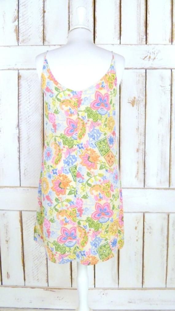 "90s vintage floral paisley mini slip dress/short floral tank dress/long tunic floral boho top Measurements... -estimated fit: ladies xsmall/small -marked size: xsmall -across bust: 16\" (40.6 cm) -across waist: 16 1/2\" (42 cm) -across hips: 19\" (48.2 cm) -length: 34\" (86.4 cm) Features... -pretty floral and paisley pattern in soft feminine colors -soft and lightweight rayon crepe...perfect for those hot days -darling ruffled detail with a mini floral accent -slip on style -perfect as a mini Multicolor Paisley Print Mini Dress For Summer, Patterned Floral Print Sleeveless Mini Dress, Summer V-neck Mini Dress With Paisley Print, Sleeveless Floral Print Patterned Mini Dress, Casual Fitted Mini Dress With Paisley Print, Fitted Casual Mini Dress With Paisley Print, Vintage Printed Summer Mini Dress, Spring Paisley Print Fitted Mini Dress, Spring Fitted Mini Dress With Paisley Print