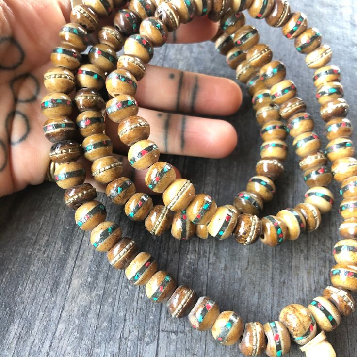 Unique and powerful Nepali Yak Bone Mala. Each bead has bras and small stone details. A unique unisex piece that will be perfect for your day by day outfits. The Mala is 40.6cm- 16 inch long A most have addition to your jewelry collection. Enjoy Con salud Spiritual Wooden Beads Jewelry For Meditation, Bohemian Round Brown Beads, Wooden Beads Amulet Necklace As A Gift, Wooden Beads Amulet Necklace For Gift, Amulet Style Wooden Beaded Necklace For Gifts, Amulet Style Wooden Beaded Necklaces For Gifts, Spiritual Wooden Beads Jewelry For Healing, Spiritual Round Beads Jewelry For Festivals, Amulet Style Wooden Beaded Necklace As Gift