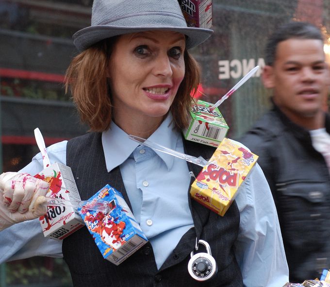 a woman wearing a hat and holding some candy