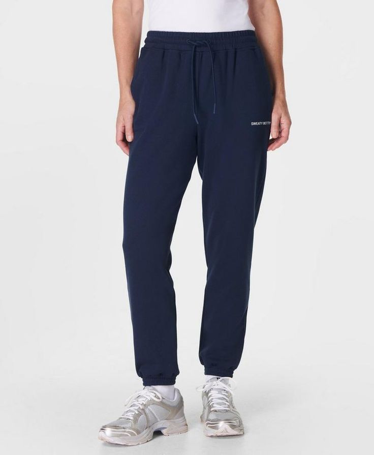 A relaxed new take on our elevated sweatpants. Made from a soft and breathable French terry cotton blend. Loose fit with sporty side panel stitching. Elasticated cuffs and a drawcord at the waist  . Two side pockets. Inseam length: 71.5cm /  28”. Model wears size S and is 178cm/5'10" tall. Style Code: SB9915Colour: Navy Blue Sporty Relaxed Fit Sweatpants With Ribbed Cuffs, Sporty Sweatpants With Ribbed Cuffs And Relaxed Fit, Sporty Sweats With Drawstring For Loungewear, Sporty Drawstring Sweats For Loungewear, Sportswear Sweatpants With Functional Drawstring, Relaxed Fit Athleisure Sweats With Drawstring, Sporty Sweatpants With Functional Drawstring For Jogging, Sporty Sweatpants With Elastic Cuffs For Everyday, Sporty Joggers With Ribbed Waistband For Loungewear