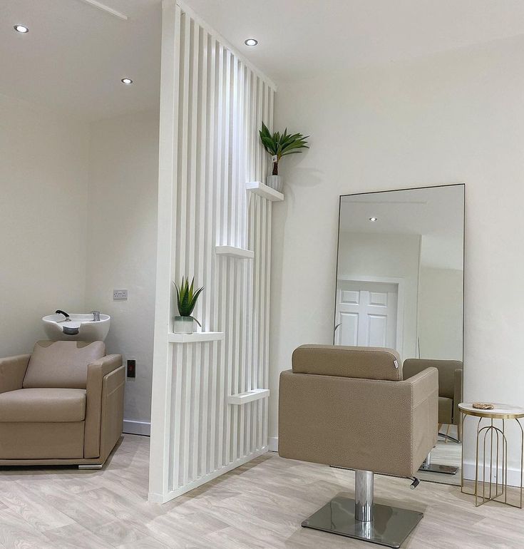 a chair and mirror in a room with white walls