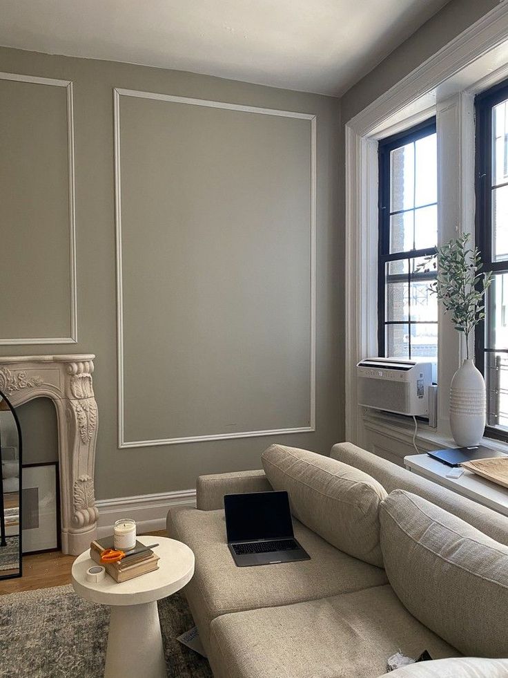 a living room filled with furniture and a fire place in front of a large window