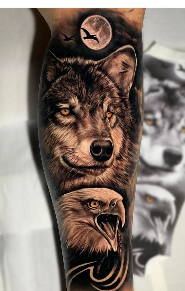 an arm tattoo with two wolfs and one eagle on it's left forearm