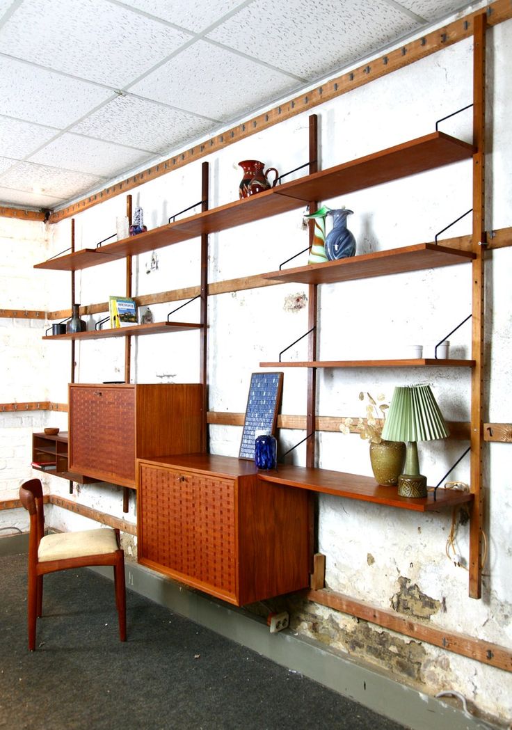 a room with shelves and chairs in it