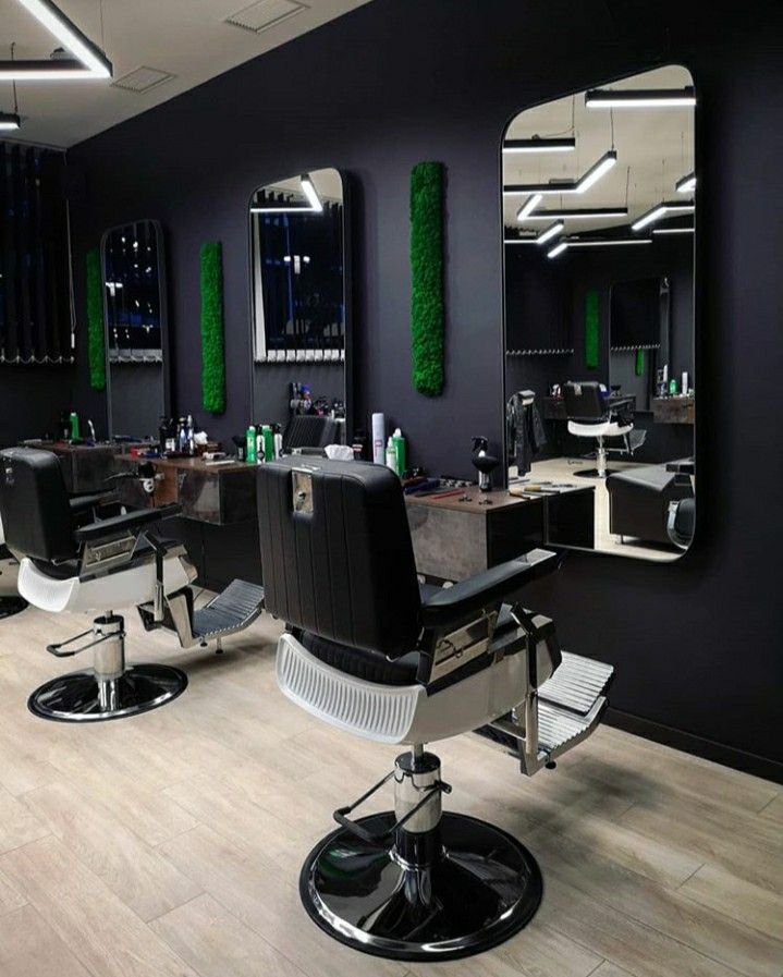 a hair salon with chairs and mirrors on the wall next to it's lights