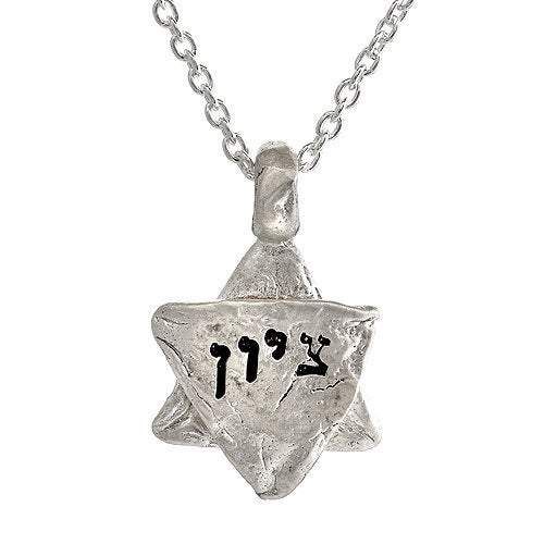 Description and Details ציון TZION Zion Zion is often used as a synonym for Jerusalem. Sterling silver charm imprinted with texture from the stones of the Western Wall in Jerusalem. Inscribed in Hebrew Pendant size is 5/8″ (20mm) Chain length 16″ (42cm) 63 x .63 in HWN2B