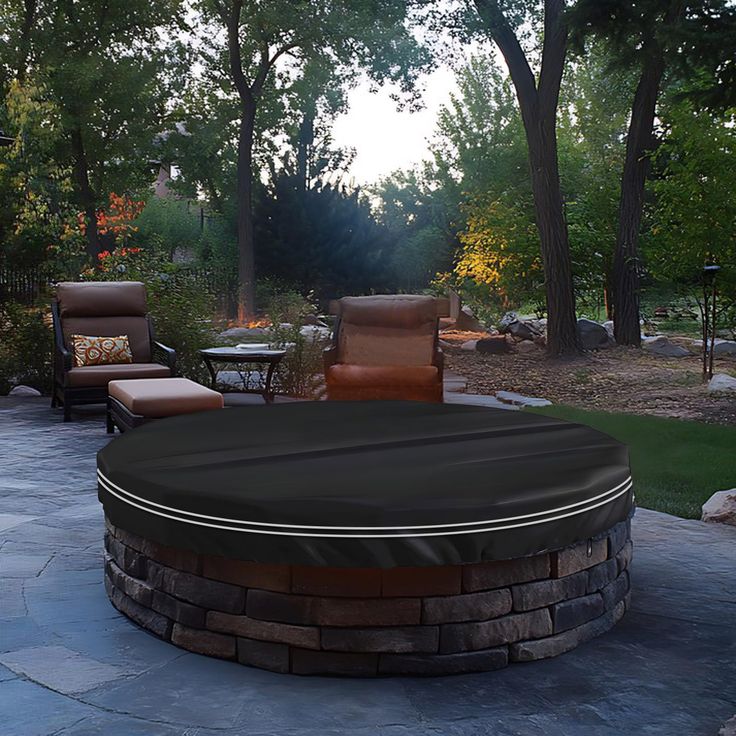 a fire pit surrounded by patio furniture and trees