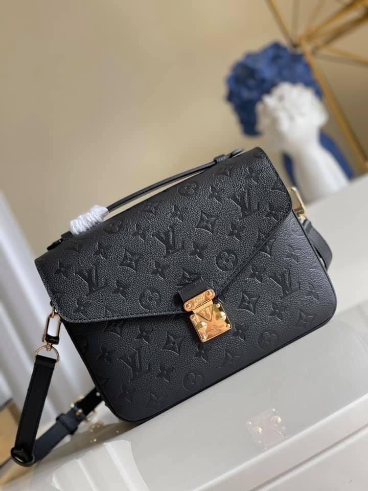 The Pochette Métis handbag is a chic, scaled-down version of the classic satchel silhouette. This covetable model is crafted from supple Monogram Empreinte leather, accented with an S-lock closure inspired by historic House trunks. Versatile, compact and surprisingly roomy, it is fitted with a stylish top handle and a detachable strap for shoulder or cross-body wear. Detailed Features 25 x 19 x 7 cm / 9.8 x 7.5 x 2.8 inches (Length x height x width ) Black Monogram Empreinte embossed supple grai Lv Pochette Metis, Louis Vuitton Pochette Metis, Lv Pochette, Louis Vuitton Crossbody, Lv Bags, Stylish Top, Louis Vuitton Pochette, Crossbody Tote Bag, Lv Handbags