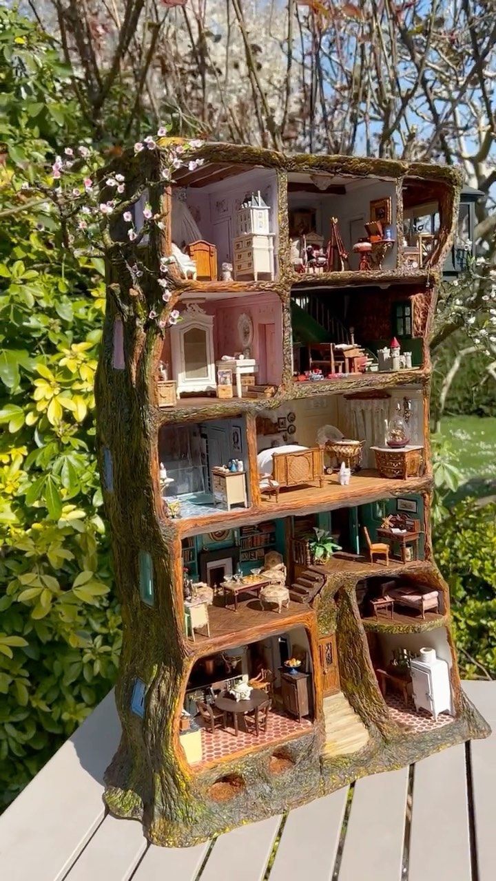 a doll house built into the side of a tree