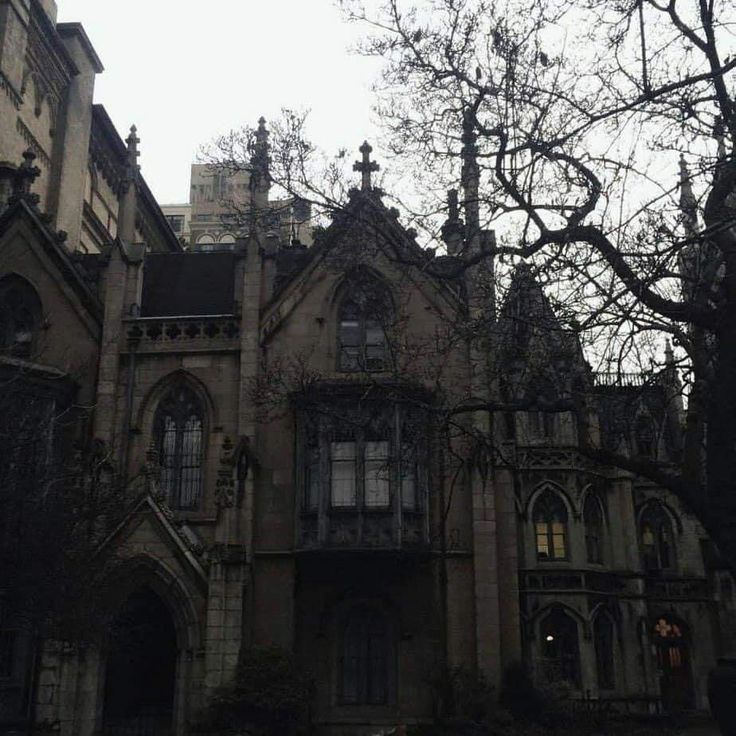 an old building with lots of windows and trees