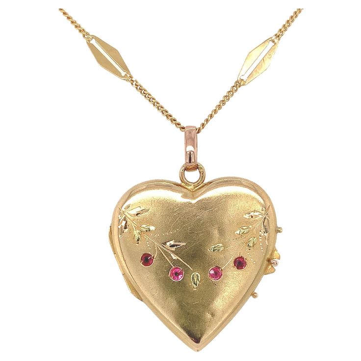 18K yellow gold heart shaped locket with applied green gold leaves and 4 small synthetic ruby accents. There is a French eagle hallmark on the loop attached to the heart. The heart also has engraved leaves and branches. The synthetic rubies each measure about 1.3mm. There are some minor dings and dents. The locket measures 1 1/4" long with bail and 15/16 or just under 1" wide. The 18K gold chain has 18 specialty diamond shaped links and measures 24". The necklace weighs 6.23dwt. It dates from the 1940's. Heart Shape Locket, Heart Shaped Locket, Leaves And Branches, Heart Necklaces, 18k Gold Chain, Gold Locket, Rose Gold Heart, Gold Leaves, Diamond Shaped