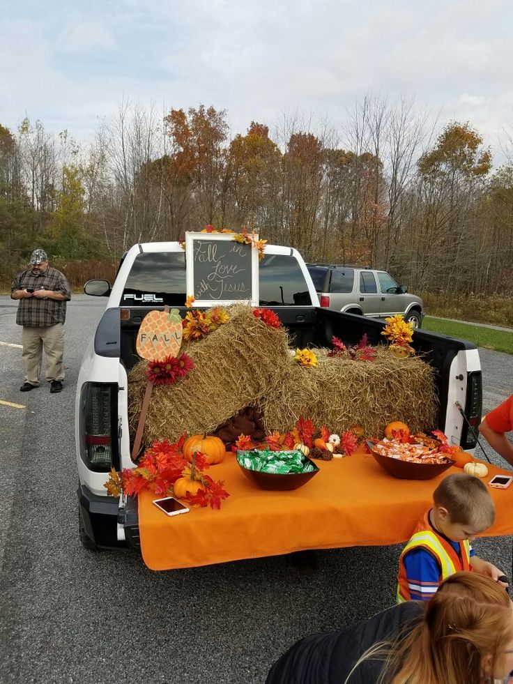 a truck is decorated with hay and pumpkins