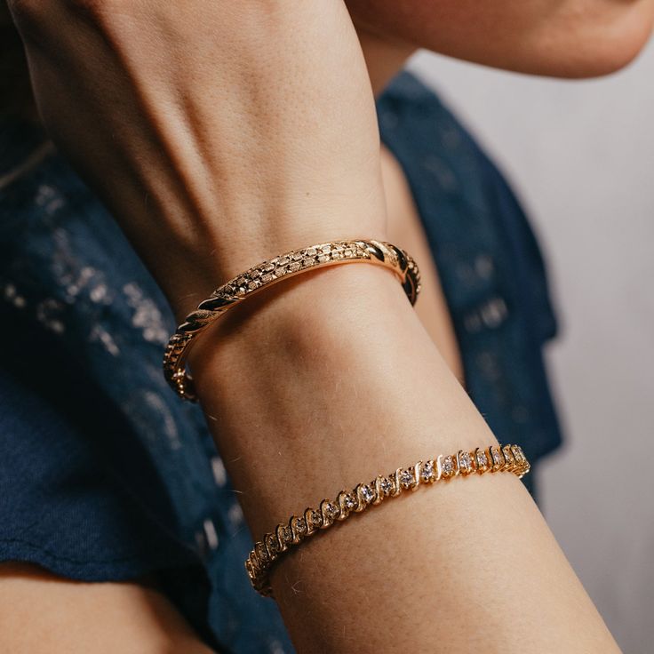 This 18k yellow gold bangle bracelet is hand engraved and features faceted and textured metal. It'll add warmth and sparkle to any look, perfect for any occasion! The inner circumference is 6.75 inches, and opens with a hinge for easy access. Its is held tightly in place with a security clasp. Pictured alongside the Yellow Gold & Natural Diamond Tennis Bracelet Tarnish Resistant Gold Bangle For Everyday Luxury, 14k Gold Oyster Bracelet Bangle For Formal Occasions, Gift Diamond Cut Bangle Chain Bracelet, Classic Gold-plated Diamond Bangle Bracelet, Classic Gold Plated Diamond Bangle Bracelet, Formal Diamond Bangle Bracelet With Oyster Detail, Formal Diamond Cut Bangle Cuff Bracelet, 14k Gold Bangle Tennis Bracelet With Single Cut Diamonds, Tarnish Resistant Bangle Chain Bracelet For Anniversary