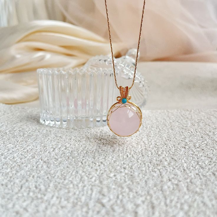 Embrace the gentle energy of love and healing with this handmade Rose Quartz 21mm Bead Pendant Necklace. The soft pink hues of the Rose Quartz beads radiate peace and harmony, while the stylish pendant adds a touch of elegance to any outfit. This necklace is perfect for those seeking to attract love and positive energy into their life, making it a meaningful gift for yourself or a loved one. Wear this beautiful piece as a daily reminder to open your heart to compassion and self-love. Product Det Rose Quartz Pendant Necklace In Rose Gold, Rose Gold Pendant Necklace With Rose Quartz, Rose Gold Rose Quartz Jewelry For Meditation, Rose Quartz Gemstone Necklaces For Meditation, Rose Quartz Gemstone Necklace For Meditation, Pink Jewelry For Meditation, Rose Quartz Pendant Necklaces For Healing, Pink Spiritual Crystal Gemstone Necklace, Pink Spiritual Gemstone Crystal Necklace