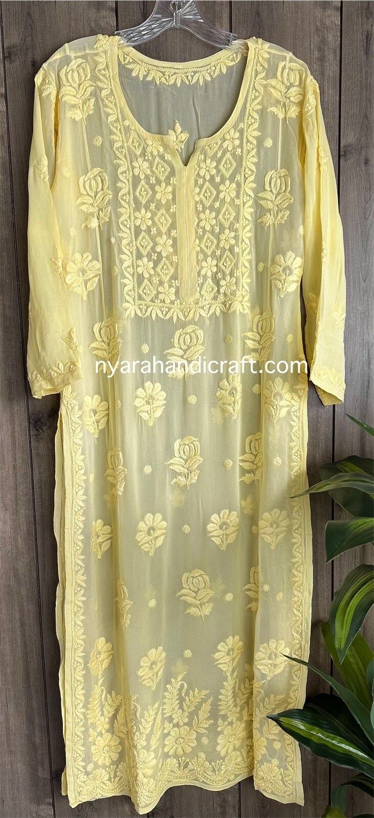 "Chikankari hand embroidered kurta on georgette.  Trendy \"ghaas patti\" embroidery on a fine fabric. Kurta length: 50 inches Liner included Pair it with a white Chikankari palazzo or  pants for a complete look!" Luxury Bollywood Tops With Chikankari Embroidery, Luxury Elegant Top With Chikankari Embroidery, Georgette Kurta With Floral Embroidery For Navratri, Yellow Georgette Kurta With Floral Embroidery, Traditional Georgette Kurta With Floral Embroidery, Yellow Embroidered Georgette Kurta, Yellow Georgette Kurta For Transitional Season, Transitional Yellow Georgette Kurta, Festive Georgette Kurta With Cutwork