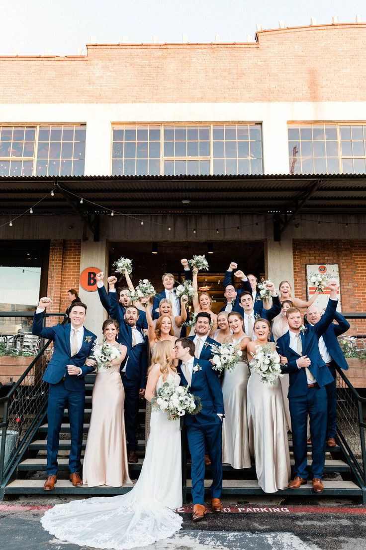 a group of people standing on top of a set of steps in front of a building