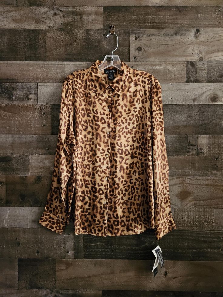 Vintage Cheetah or Leopard Print Blouse  *  Signature - Jones New York *  100% Silk Fabric  *  Label Size XL - See Measurements *  Tags Still Attached  *  New Condition *  Tan Brown Leopard Print 46"  Bust  44"  Mid Section - Waist Area 16"  Shoulders 26"  Length  24" Sleeve Length Very Nice Condition - No issues to disclose unless noted above - Ships Promptly and with care. Exact colors are not always easy to achieve in photos.  I try my best to describe accurately.  If you need to have a specific color or color match something, Please contact me for more information. Please keep in mind that this is a vintage item. It has been pre-loved & is likely not in perfect new condition but certainly wearable and ready to enjoy. Look at all photos carefully as they are part of the description. All Vintage Leopard, Printed Silk Blouses, Fabric Labels, Leopard Print Blouse, Brown Leopard, Label Sizes, Print Blouse, Jones New York, Tan Brown