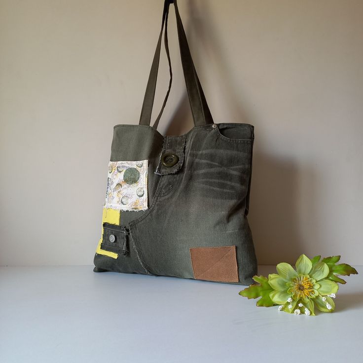 Introducing our **unique upcycled denim tote bag a one-of-a-kind accessory that combines style and sustainability. This thoughtfully crafted bag is made from a new pair of thick denim, showcasing a vibrant mix of yellow and olive green fabrics. The addition of natural leather details enhances its chic aesthetic, making it a perfect statement piece for any outfit. Measuring 36 cm in height, 35 cm in width, and 6 cm in depth, this tote is designed for everyday use as well as weekend getaways. The bag features two exterior pockets--one on the front and one on the backside--allowing for easy access to your essentials. Inside, it is lined with a matching cotton fabric and includes a zippered inner pocket for added organization. The sturdy button closure ensures security while the two top handle Trendy Upcycled Tote Bag, Trendy Upcycled Shoulder Bag For Everyday, Canvas Patchwork Shoulder Bag For Everyday, Everyday Canvas Patchwork Shoulder Bag, Trendy Upcycled Bags For Daily Use, Green Patchwork Shoulder Bag For Everyday, Green Casual Upcycled Bags, Casual Green Upcycled Bags, Everyday Green Patchwork Shoulder Bag