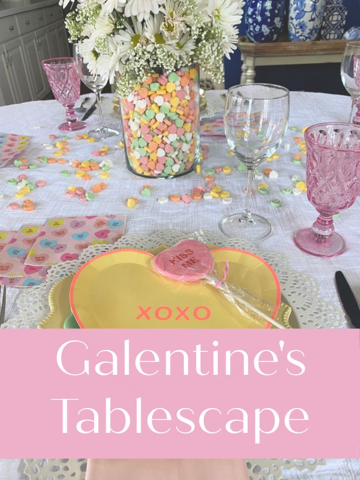 the table is set for valentine's day with pink and white flowers