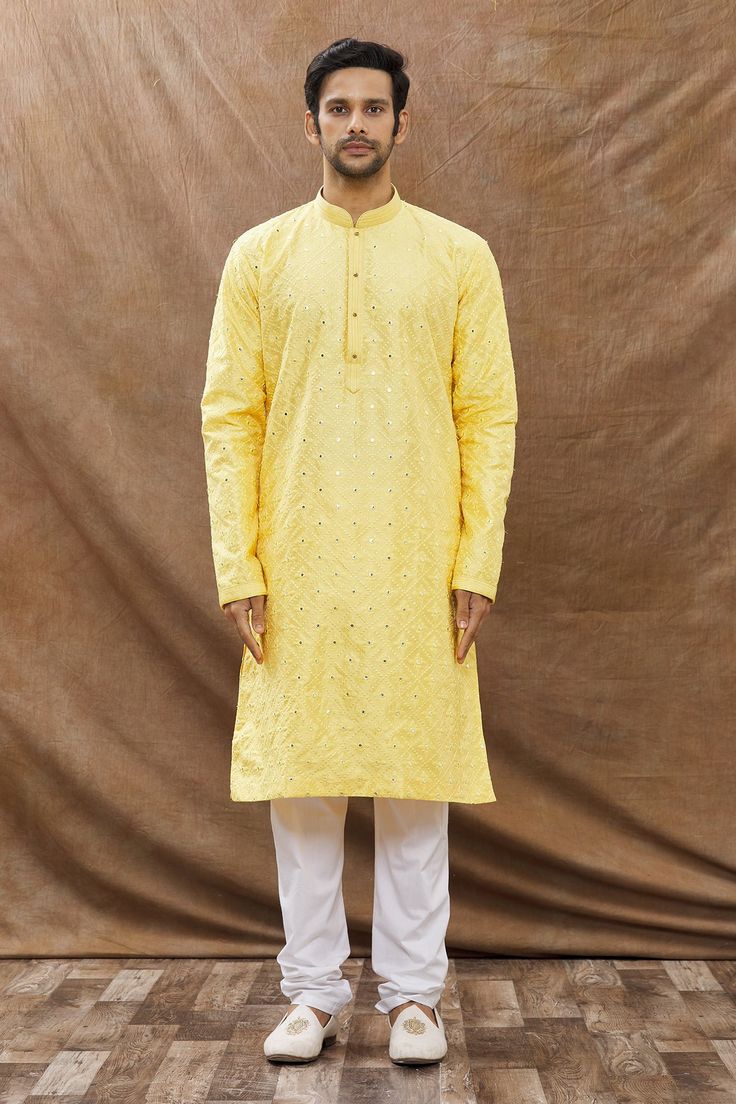 Yellow kurta with mirror embroidered motifs and mandarin collar. Paired with churidar.
Component: 2
Pattern: Embroidered
Type Of Work: Mirror
Neckline: Mandarin
Sleeve Type: Full Sleeves
Fabric: Cotton
Color: Yellow
Other Details: 
Embroidered motifs
Front buttons
Occasion: Mehendi,Sangeet - Aza Fashions Yellow Mirror, Yellow Kurta, Kurta Set For Men, Embroidered Motifs, Churidar, Kurta Set, Full Sleeves, Mandarin Collar, Aza Fashion