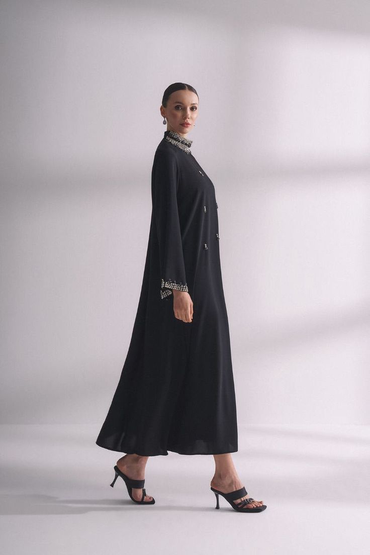 Step out in style and elegance with our Jewel neck with rhinestone Abaya. This beautiful and modest garment features a stunning jewel neck design embellished with rhinestones, making it perfect for special occasions or everyday wear for Muslim women looking for a touch of luxury. Product Features: - Jewel neck design with rhinestones adds a touch of glamour to your look. - Made from high-quality, comfortable fabric for all-day wear. - Modest and elegant design is perfect for a range of occasions Modest Blue Dress, Modest Outfit, Evening Jumpsuit, Maxi Dress Formal, Abayas Fashion, Jewel Neck, Muslim Women, Everyday Wardrobe, Modest Outfits