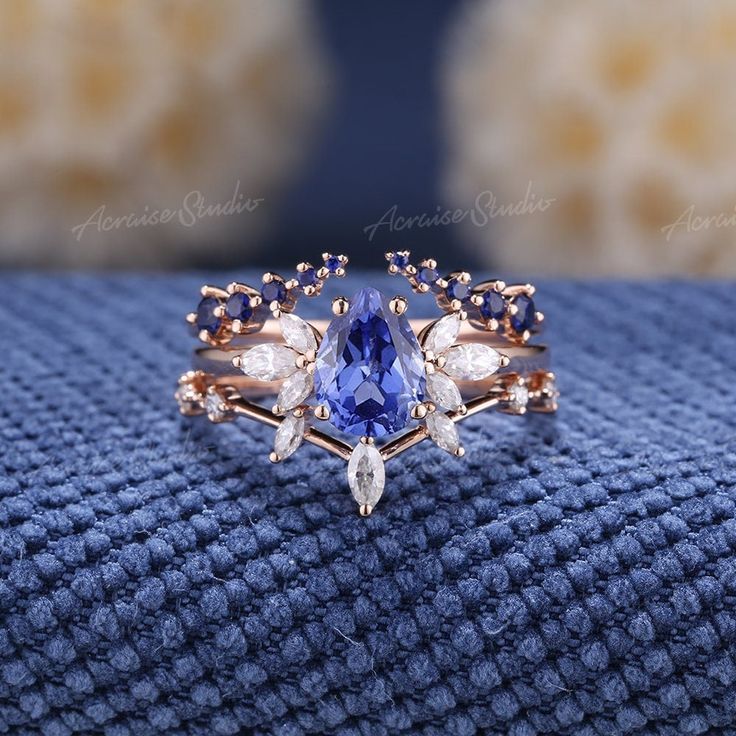 Pear Shaped Cornflower Sapphire Engagement Ring Set 3pcs Art Deco Wedding Rings Women Rose Gold Marquise Diamond Sapphire Wedding Band If you want a men's ring to match this ring, you can take a look at this one. https://www.etsy.com/listing/1535832513/vintage-white-gold-sapphire-mens-rings?click_key= Jewelry Information: ♡ Handmade, high-quality item ♡ Material: SOLID 14K/18K GOLD ( can be made in yellow/white/rose gold ) ♡ Engagement ring ♡ Center stone: Lab grown sapphire  ♡ Size/Weight:  8x6mm  ♡ Cut - Pear Shaped ♡ Color: cornflower blue ♡ Side stones: Moissanite/ Natural diamonds ♡ Weight:  About 0.28ct ♡ Cut - Marquise Shaped ♡ Clarity - SI-VS ♡ Color- G-H ♡ Band Width: Around 1.8mm ♡ Wedding band 1 (top) ♡ Stone: Natural light blue sapphire ♡ Weight: About 0.2ct ♡ Cut - Round Shape Engagement Rings With Blue Sapphire, Wedding Rings Cinderella, Blue Wedding Rings Sets His And Hers, Water Inspired Engagement Ring, Unique Engagement Rings Sapphire Bridal Sets, Engagement Rings For Him And Her, Blue Safire Wedding Ring, Wedding Ring Gemstone Unique, Crown Engagement Ring Set