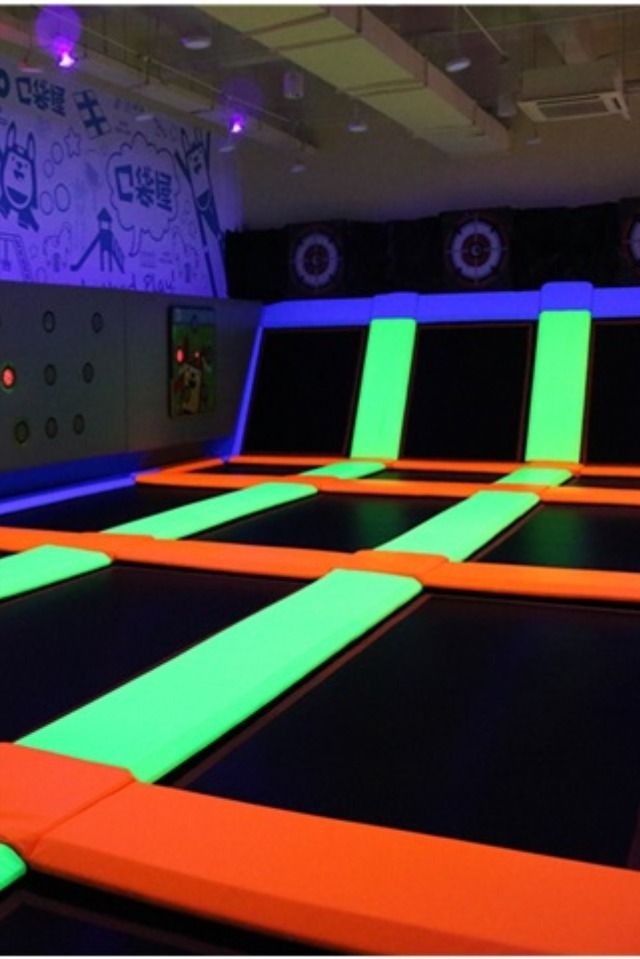 an indoor trampoline course with neon lights