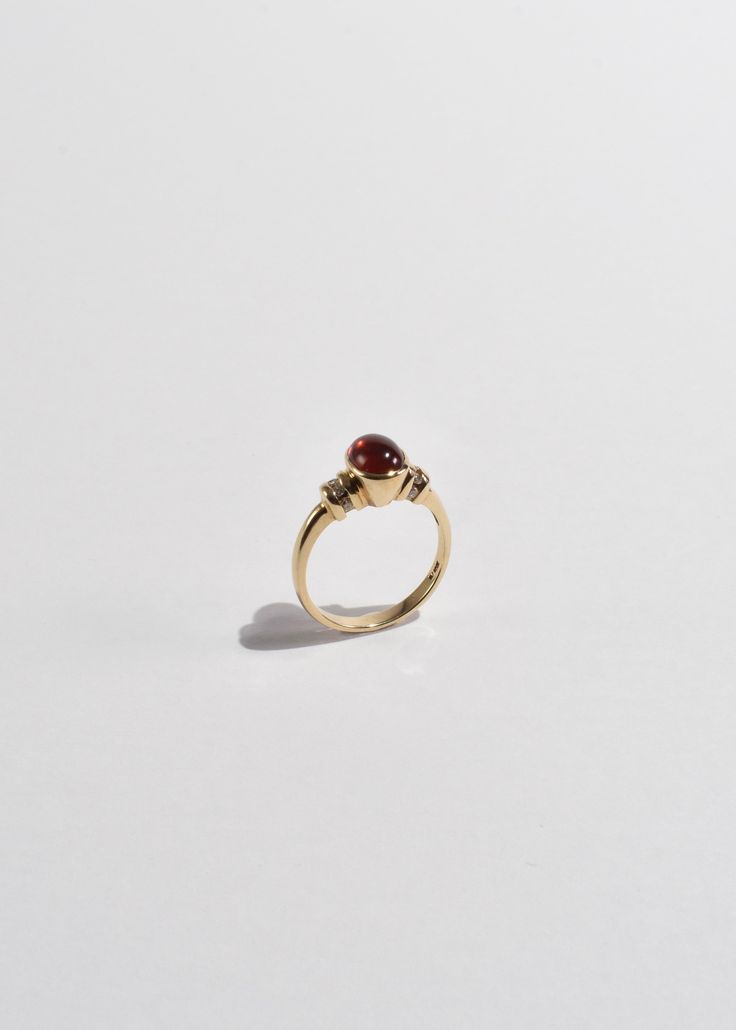 Beautiful vintage gold ring with a polished ruby cabochon and diamond detail. Stamped 10k. Material: 10k gold, ruby, diamond. We recommend storing in a dry place and periodic polishing with a cloth. Classic Yellow Gold Sapphire Ring With Cabochon, Heirloom Yellow Gold Diamond Ring With Oval Cabochon, Classic Ruby Ring With Polished Round Stone, Classic 14k Gold Sapphire Oval Cabochon Ring, Oval Cabochon Ruby Ring With Diamonds, Timeless Red Ring With Polished Finish, Ruby Signet Ring With Bezel Setting For Formal Occasions, Formal Ruby Signet Ring With Bezel Setting, 14k Gold Gemstone Dome Ring Fine Jewelry