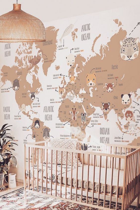 a baby's room with a large map on the wall and a crib