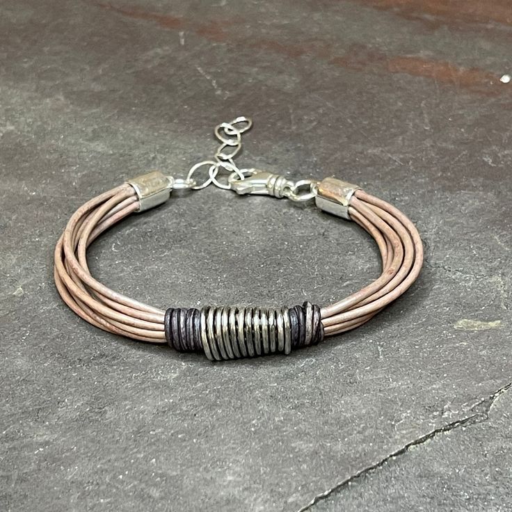 Perfect last bit of summer vibe.  Some soft, sandy vegetable dyed leather with a center of handmade pure (.97 -.99) silver,  Finished with a sterling silver swivel lobster clasp and chain, for sizing from 6.5" - 8".   Looks great alone or paired with gemstones, more leather, or simple silver bangles.   This will be a limited style so get yours while you can.   Thanks so much for stopping by today, and for supporting small, artisan, and handcrafted goods businesses. Handmade Leather Bracelets For Everyday, Handmade Leather Bracelet For Everyday, Everyday Handmade Leather Bracelets, Handmade Waxed Cord Leather Bracelet, Handmade Waxed Cord Leather Bracelet For Everyday, Everyday Handmade Leather Bracelet, Bohemian Leather Jewelry For Everyday, Bohemian Everyday Leather Jewelry, Casual Everyday Jewelry With Leather Strap