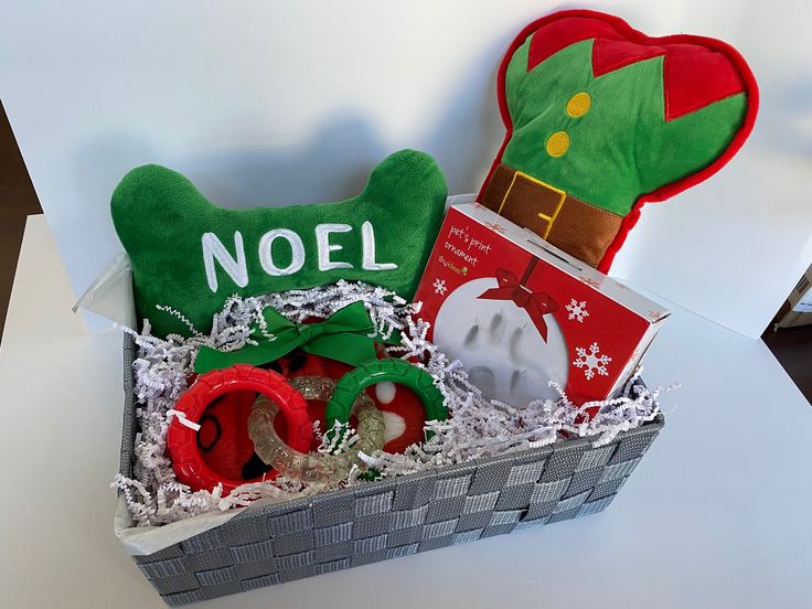 a christmas gift basket with an elf hat and other holiday items