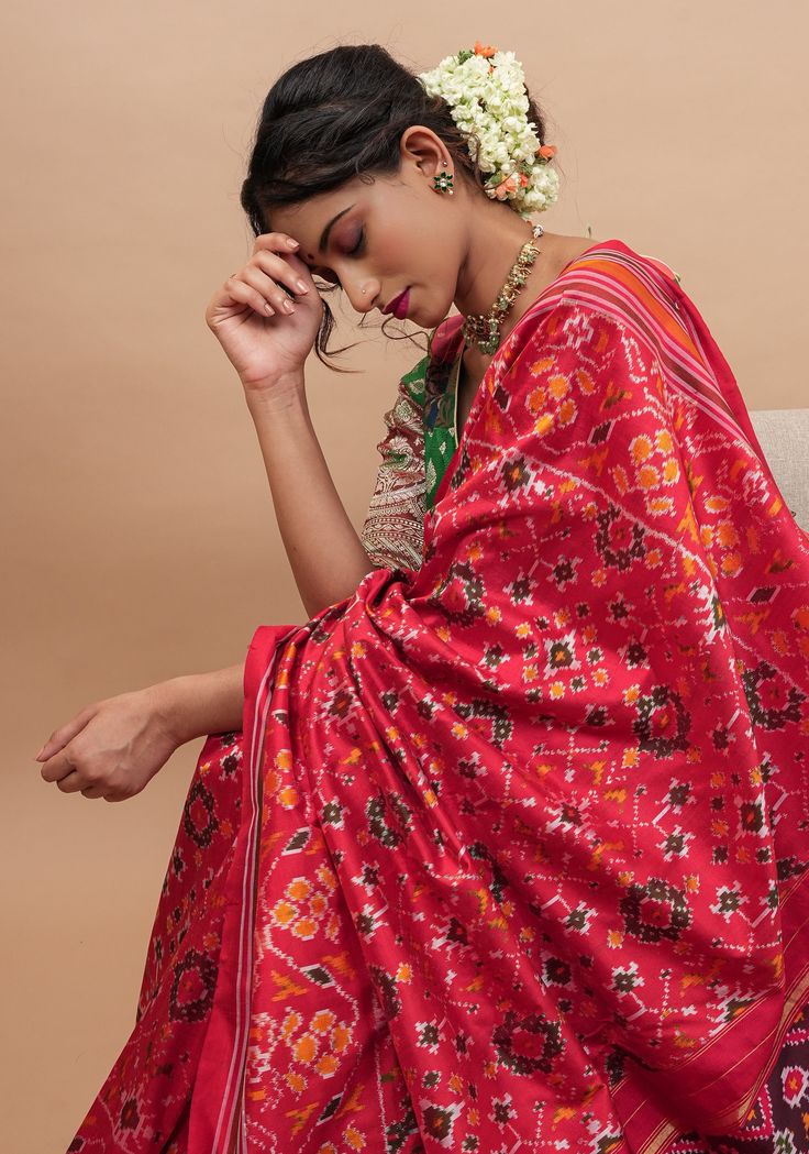 Ikkat Sarees are exquisite and for all the right reasons! This beautiful saree comes in a bold and beautiful red and has intricate Ikkat patterns woven all over the body! Set on pure silk and handwoven to grace, this saree is sure to make you mark your presence! SILK MARK CERTIFIED This saree is ready to wear with fall and pico done. Handmade silk tassels adorn the pallu and add more grace to it. An unstitched blouse fabric is included. *Note: There may be minor variations in the shade, the text Red Embroidered Saree For Navratri, Red Saree For Navratri, Red Unstitched Saree For Navratri, Red Sharara With Zari Weaving For Designer Wear, Luxury Tussar Silk Saree For Navratri, Designer Red Paithani Silk Traditional Wear, Designer Red Dupatta With Zari Weaving, Designer Red Choli With Zari Weaving, Red Sharara With Zari Weaving For Puja