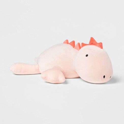 a pink stuffed animal with an orange crown on its head and tail, laying down