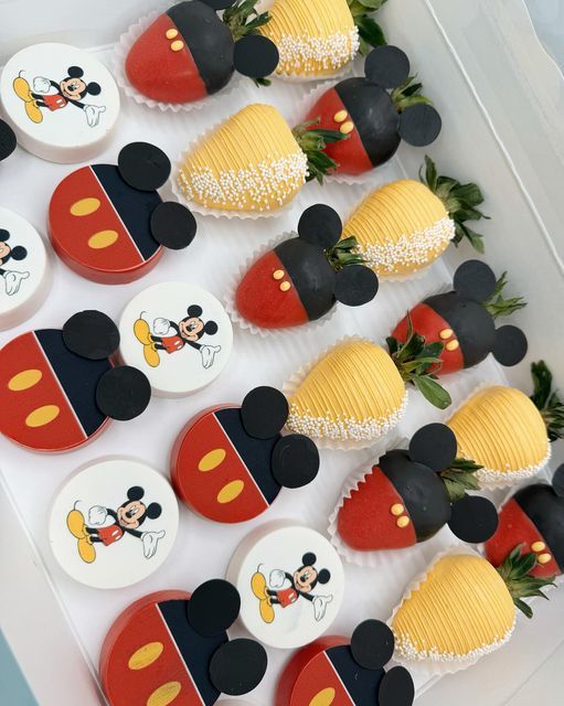 mickey mouse cupcakes are arranged on a tray