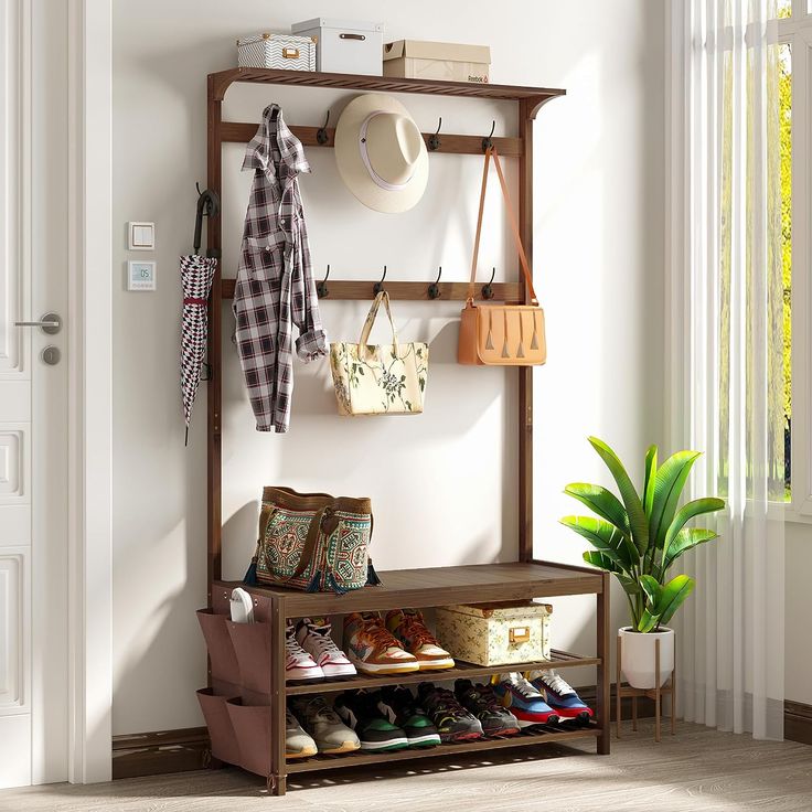 Transform your entryway with AMBIRD's versatile hall tree! Crafted with a sturdy bamboo frame, it's a 6-in-1 marvel: a shoe bench, coat rack, and storage bench all rolled into one. With 14 coat hooks and a handy cloth bag, it's designed to keep your space tidy and welcoming. Its large size ensures ample storage, while the warm brown finish complements any decor. Perfect for those who love organized elegance. #EntrywayEssential #OrganizedLiving Shoe Storage Shelves, Shoe Storage Shelving, Bench With Coat Rack, Coat Rack Shoe Bench, Shoe Bench Entryway, Bench Entryway, Shoe Rack Bench, Shoe Storage Shelf, Shoe Shelves