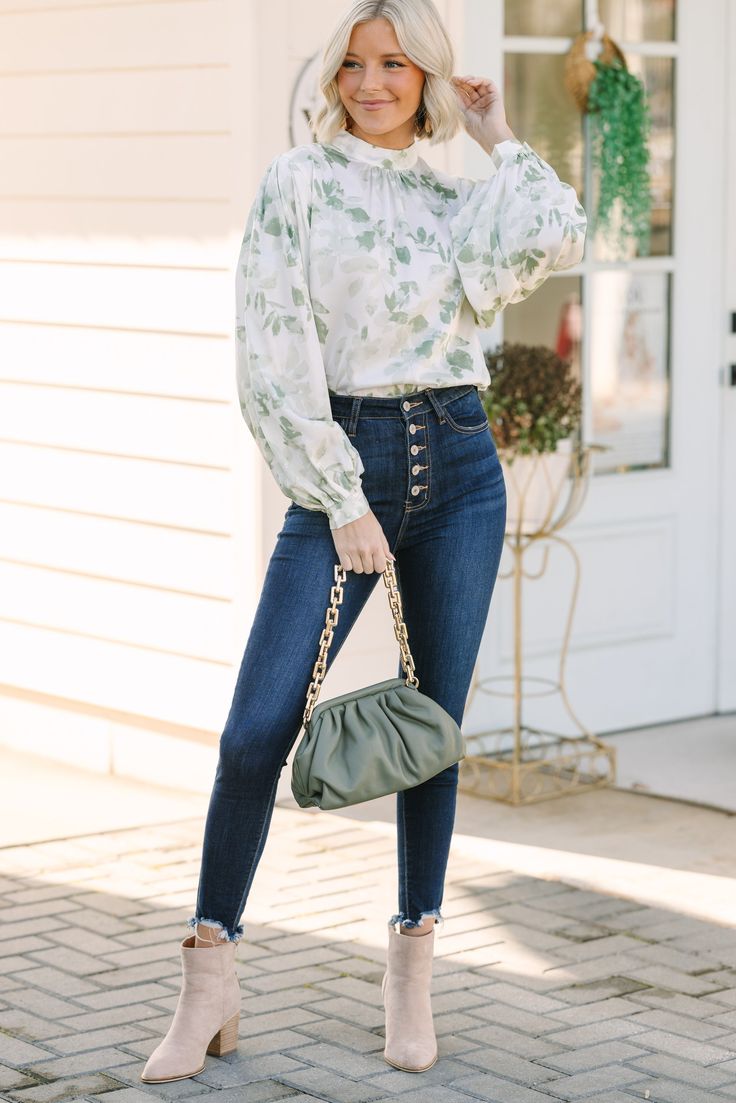 You are going to have this blouse on your mind! It's stunning! That floral print is so chic and we love the soft coloring. You can style this blouse for a day at the office or for any occasion where you want to feel like you have it all together! Mock neckline Button keyhole back Long bubble sleeves Floral print Satin fabric No stretch Payton is wearing the small. Feminine Blouse For Day Out In Fall, Chic Floral Print Long Sleeve Blouse, Chic Long Sleeve Blouse With Floral Print, Chic Floral Print Blouse For Fall, Chic Floral Print Blouse For Brunch, Versatile Blouse For Fall Brunch, Trendy Floral Print Blouse For Work, Trendy Floral Print Blouse For Day Out, Green Floral Blouse