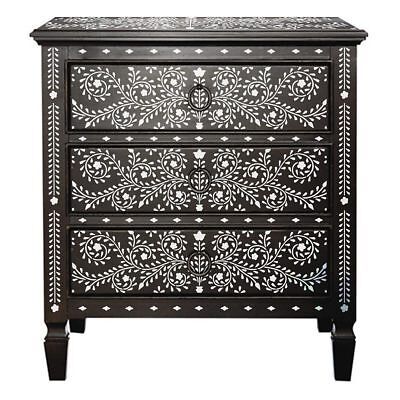 an ornate black and white cabinet with drawers