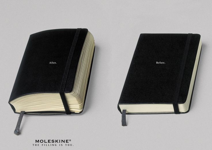 two black notebooks sitting side by side on top of each other with the same bookmark