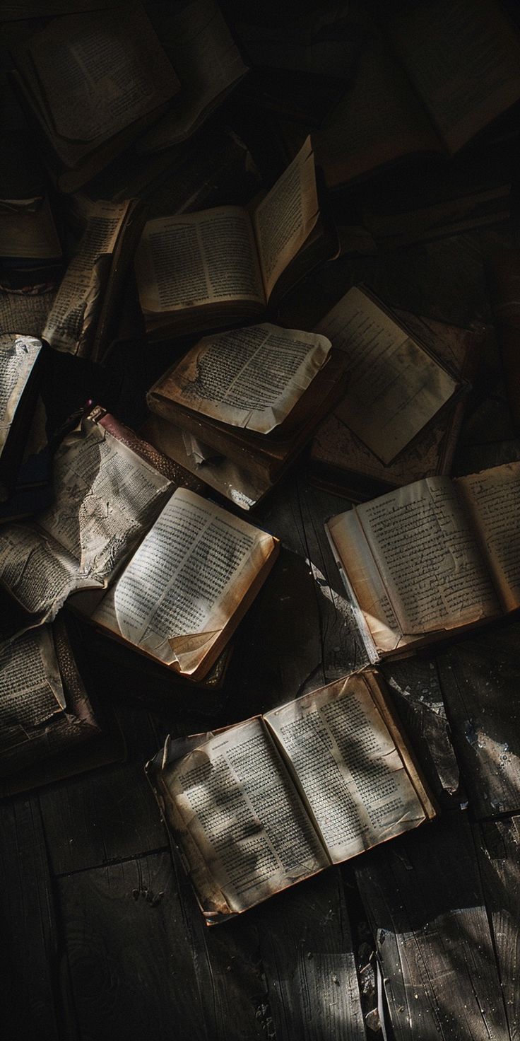 an open book laying on top of a pile of books