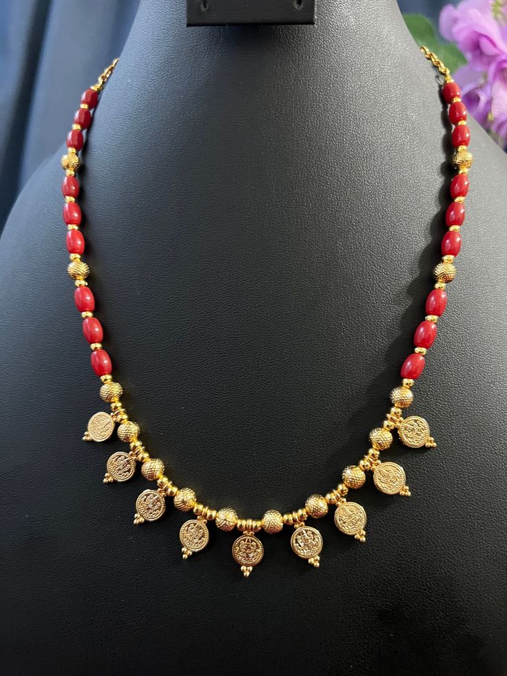 Goddess Lakshmi Small Coin/Coral Gold Beads/Gold Finish One Line Long Haram 21 inches /one Haram only/ Give Gift Haram/South Indian Jewelry. This item is perfect to whear any time for parties and festivals! DETAILS: Includes Only One Necklaes Line Haram . Necklace: 21  inches. Chain closure. Weighs 1.45 oz (41 g).  Earrings:  Material: Imitation gold Beads Coral Beads Gold Finish  Finish: Premium gold finish.  NOTE: I try my best to show you photos of my products as they appear in real life, but please note that variations in color occur due to differences in lighting and screen settings.  PRODUCT CARE: - Avoid contact with heat/fire, water, and chemicals such as perfumes or any sprays to prevent product damage.  - Store wrapped in butter paper, cotton cloth, or the provided box. Traditional Bridal Necklace With Dangling Round Beads, Traditional Gold Dangling Beads, Gold Dangling Beads For Festivals, Gold Temple Jewelry Beads With Dangling Details, Festive Kundan Necklace With Beaded Chain, Traditional Tiny Beads Necklace For Festivals, Traditional Beaded Chain Beads For Celebration, Handmade Oval Beads Necklace For Festivities, Traditional Red Necklace With Tiny Beads