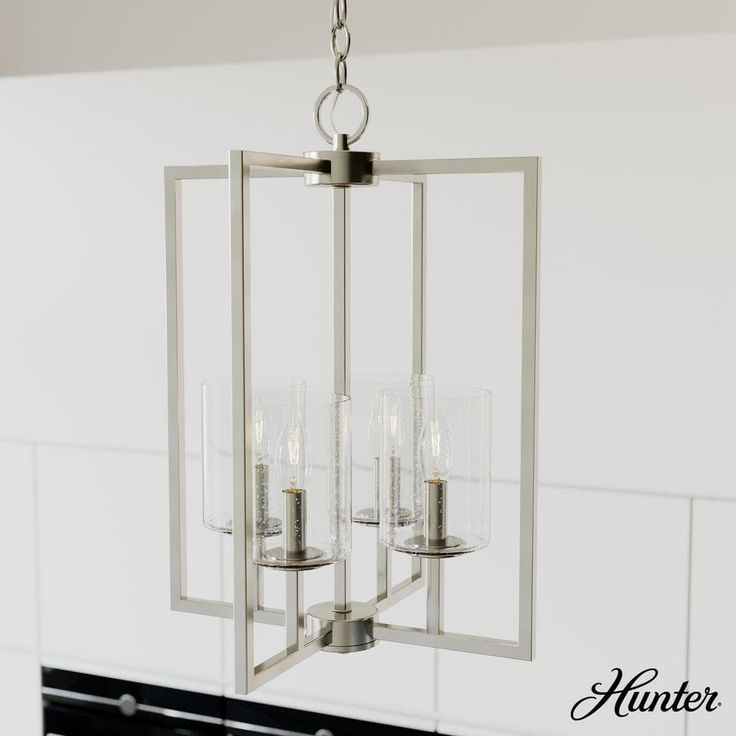 a chandelier hanging from the ceiling in a kitchen