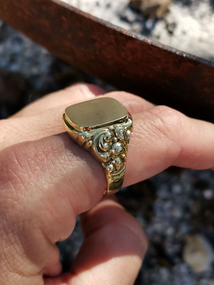 Wonderful vintage mid-century German men's signet ring, blank cartouche and ready to engrave with your initials, symbol, etc., massive 8k gold with two hallmarks (gold & maker's mark). The ring head has a decorative wreath on the side that emphasizes elegance, and a hefty 4.7 g weight. Material: 8k gold, hallmarked Total weight: 4.7 g US Size: approx. 11 (EU size 65) Box on the photos not included. PLEASE LOOK AT THE PICTURES, THEY ARE PART OF THE DESCRIPTION AND ARE THE ACTUAL ITEM YOU WILL REC Rectangular 14k Stamped Signet Ring Collectible, Collectible Yellow Gold Signet Ring With Initials, Vintage Yellow Gold Signet Ring With Hallmarks, Antique 14k Gold Signet Ring Collectible, Vintage Gold Engraved Signet Ring, Gold Engraved Signet Ring Collectible, Engraved 14k Gold Signet Ring Collectible, 14k Gold Engraved Signet Ring Collectible, Heirloom 14k Gold Signet Ring With Maker's Mark